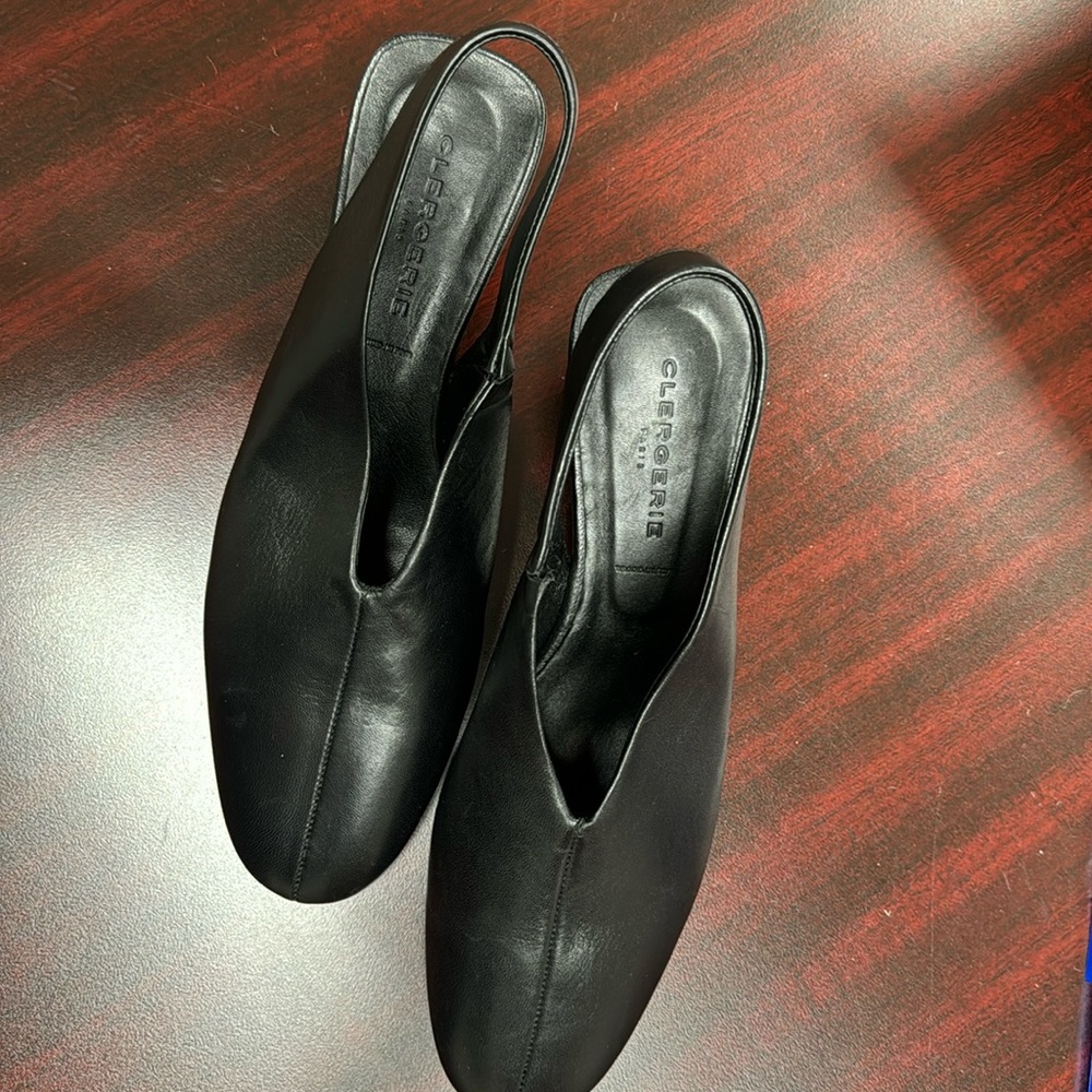 Black leather NWT Robert Clergerie pumps with decorative heel.